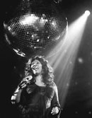 Donna Summer in spotlight with mirror ball